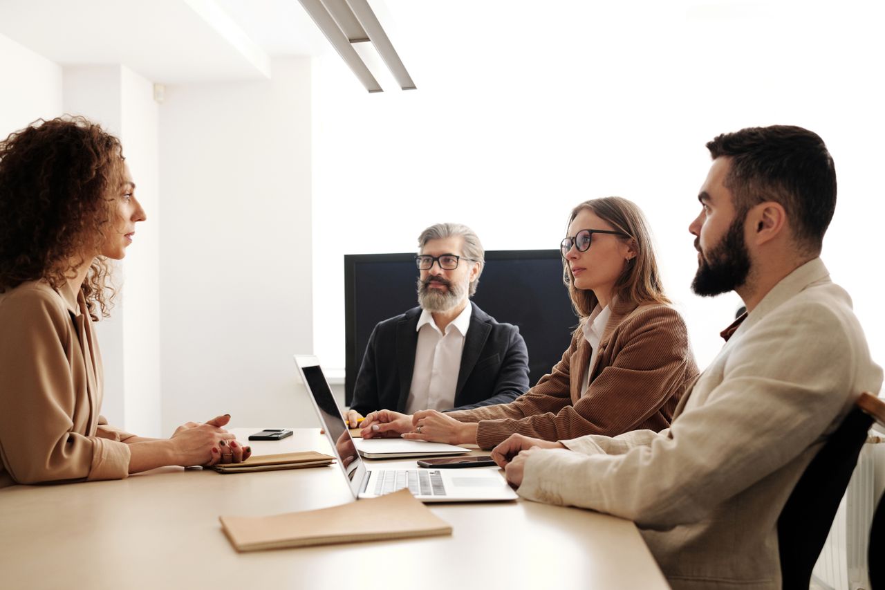 Business team meeting with diverse members collaborating in a modern office.