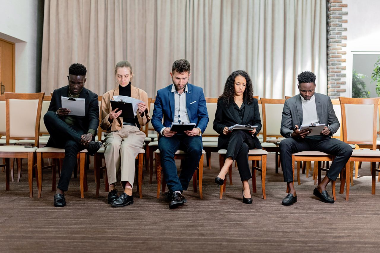 Crafting Captivating Headlines: Your awesome post title goes here A diverse group of professionals attentively reviewing documents indoors.